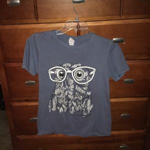 A blue shirt with an owl on it